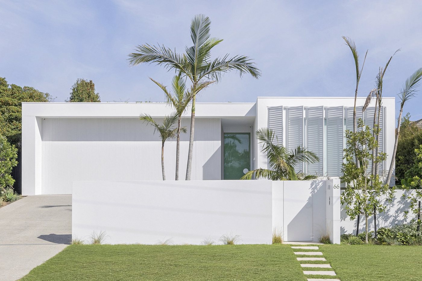 Glasshouse: white rendered residence among palms